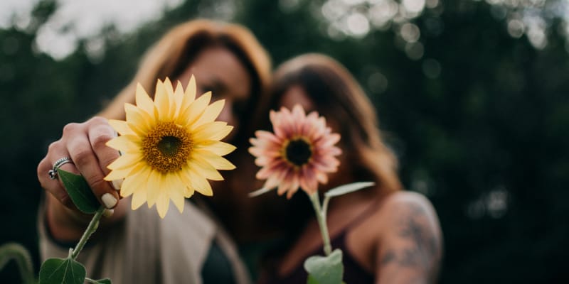 Girls holding flowers for courage is not the absence ofear