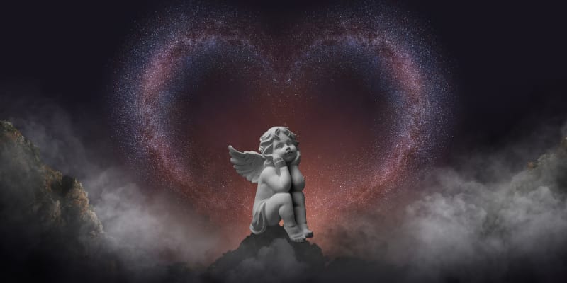 Little cupid sitting with his head on his hands